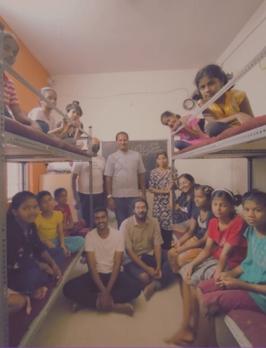 Children sitting on newly constructed bunk beds